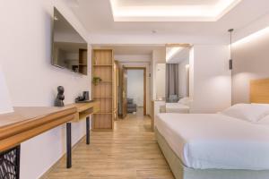 a hotel room with a bed and a desk at Archontiko Liamas in Stavros