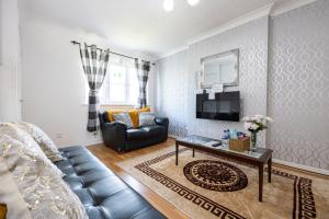 a living room with a couch and a table at Manchester Serenity House in Manchester