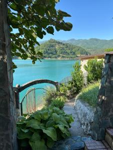 a walkway leading to a lake with a bridge at Vikendica Plavi Mir in Konjic