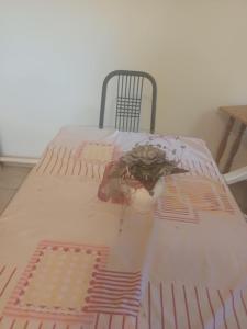 a bed in a room with a table and a chair at Tapolcai Tóparti Fészek in Tapolca