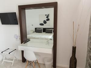 a bedroom with a white desk and a mirror at Olive Press Hotel in Mythimna +53 photos