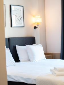 Postel nebo postele na pokoji v ubytování Hotel Admiral Vinkovci