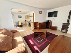 a living room with a couch and a table at Cozy Apartments Baška in Baška