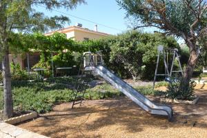 a slide in a yard with a playground at Mas Solana in Huércal-Overa +21 photos