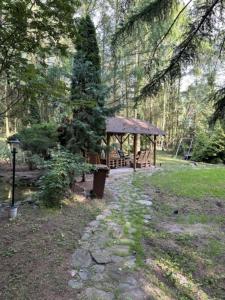 a park with a gazebo and a tree at U Poli w Gaju in Zbiczno
