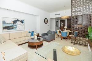 a living room with a couch and a table at Azure Crest 2BR - Ocean View Apartment Near Marina Mall in Abu Dhabi +21 photos