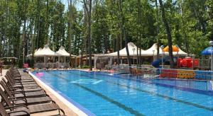 a large swimming pool with chairs and umbrellas at Apartment Privat in Sunny Beach in Sunny Beach