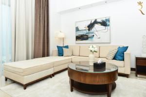 a living room with a couch and a coffee table at Azure Crest 2BR - Ocean View Apartment Near Marina Mall in Abu Dhabi