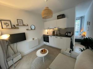 a living room with a couch and a kitchen at Cozy at home in Elst