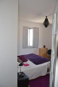 a bedroom with a bed and a window at Hostel Rossio Alcobaça in Alcobaça