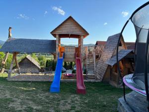 a playground with a gazebo and a slide at Pensiunea Valea Branzei in Năneşti