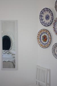 a group of plates hanging on a wall at Hostel Rossio Alcobaça in Alcobaça