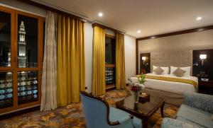 a hotel room with a bed and a table and a couch at Dar Al Taqwa Hotel in Al Madinah +187 photos