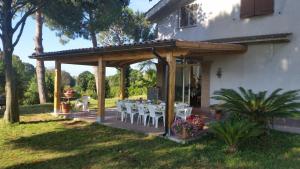 a wooden deck with tables and chairs on a house at La Finestra Sul Cortile in Pomezia