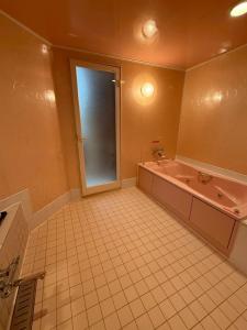 a large bathroom with a tub and a sink at HOTEL i in Takahata +9 photos