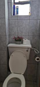 a bathroom with a toilet with a plant on top of it at The DeeLight Stay in Nairobi +11 photos
