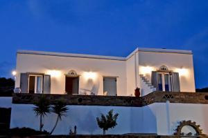 a white house at night with a blue sky at Crystal View in Triandáros