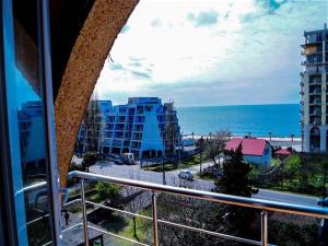 a balcony with a view of the ocean and buildings at Hotel Otsneba in Kvariati