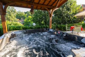 a jacuzzi tub in a backyard at Casa MT - Boutique Villa in Gabrovo