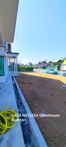 a house with a hose on the side of a yard at CASA NAYLEEA Guesthouse Kuantan in Kuantan