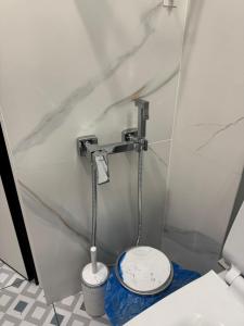 a small bathroom with a toilet in a stall at Designer apartment opposite the Airport in Almaty +19 photos