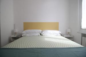 a bedroom with a large bed with two pillows at Appartamento La Gemma in Parma