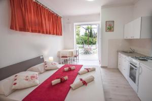 a bedroom with a bed with towels on it at Apartments-Room Srijemsi in Mlini