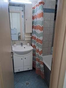 a bathroom with a sink and a shower curtain at Makis rooms A in Mesolongion