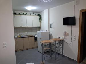 a kitchen with a small table and a refrigerator at Makis rooms A in Missolonghi