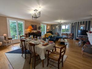 a living room with a table and chairs and a living room at La Chesnaie in Bonnes
