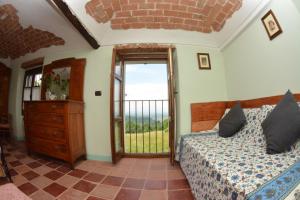 a bedroom with a bed and a window at B&B Ca' dla Nona in Brusasco