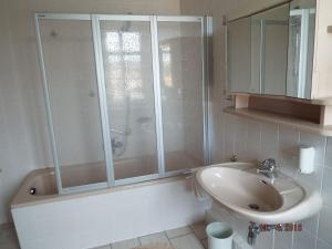 a bathroom with a shower and a sink at Hotel Pension zur Tanne in Zwickau