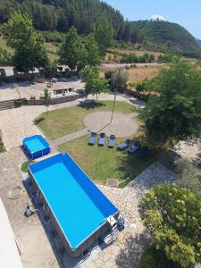 an overhead view of a swimming pool in a park at Kutal Park Inn Hotel in Përmet