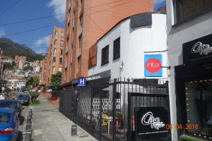 a building with a coca cola sign on it at Hotel Maceo 55 - Colonial Inn in Bogotá
