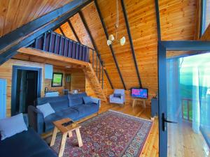 a living room with a blue couch and a staircase at Opera Bungalov 2 in Ordu