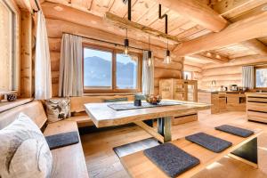 a dining room with a table in a log cabin at Sonnenchalet Bomhuesle in Dalaas +37 photos