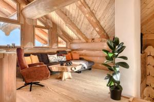a living room with a couch and a table at Sonnenchalet Bomhuesle in Dalaas