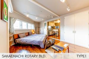 Postel nebo postele na pokoji v ubytování 栄町 ロータリービル