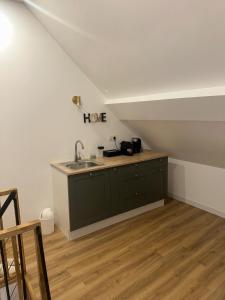 a kitchen with a sink in a attic at Spa home, Hammam in Prénouvellon