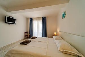 a bed in a room with a tv on the wall at Holiday House Nova in Blato +70 photos