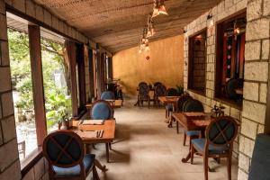 a restaurant with wooden tables and chairs and windows at Sapa Elegance Hotel in Sapa