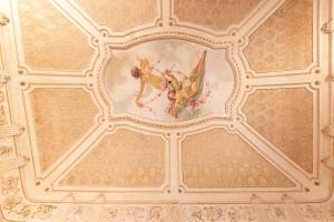 a ceiling with a painting of a dog and flowers at Vera Rooms in Catania