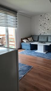 a living room with a couch and a table at Sun-Moon Apartment in Zbilje +17 photos