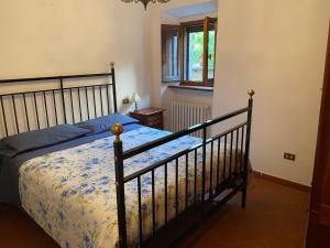 a bedroom with a bed and a window at Casa Maga in Vallo di Nera +10 photos