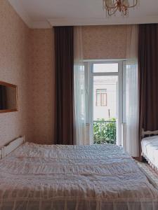 a bedroom with a bed and a large window at tata's house in Kobuleti