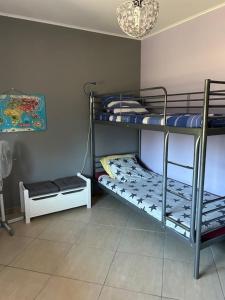 a room with three bunk beds and a chandelier at Maison idéal Familles nombreuses in Graveson