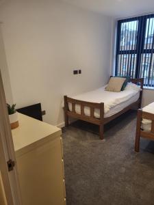 a small room with a bed and a window at Ramsgate Retreat 2 Bed Coastal Stay in Ramsgate +2 photos