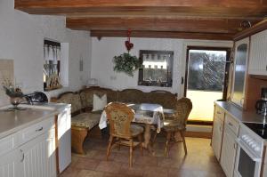 a kitchen with a table and chairs and a couch at Zum Landidyll in Lugau +19 photos
