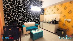 a living room with a couch and a table at Swimming Pool with Full Equipped Studio Apartment in Noida