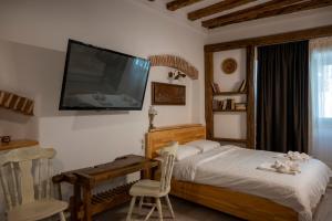 a bedroom with a bed and a television on the wall at Boutique 11 Postavarului by Kronstay in Braşov +64 photos